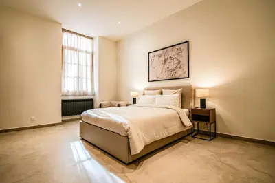 a bedroom with a bed with two lamps on it at Massena Infinity in Nice