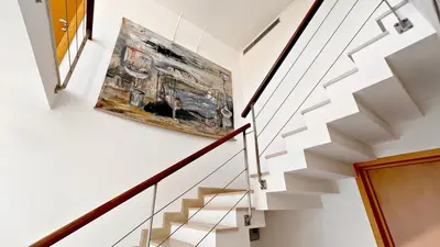 a staircase with a painting on the wall at Palm & Sun in Nice