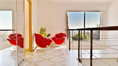 a room with two red chairs and a mirror at Palm & Sun in Nice