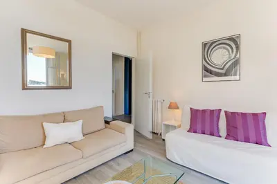 a living room with a white couch and purple pillows at BELLE DARSE AP4454 By Riviera Holiday Homes in Villefranche-sur-Mer