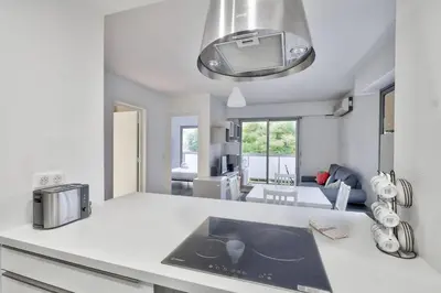 a kitchen with a white counter top with a sink at Flat with balcony 15min from Promenade des Anglais in Nice