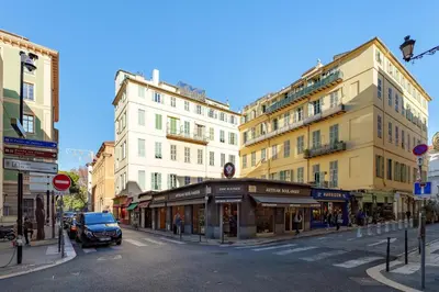 a street in a city with buildings and a car at Cocon Place Massena, Cours Saleya et Mer in Nice