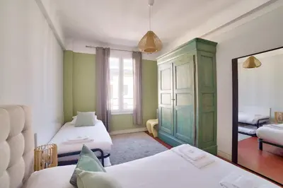a small room with two beds and a mirror at Stunning 2BR by the Port 20min Walk to the Beach in Nice