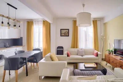 a living room with a couch and a table at Stunning 2BR by the Port 20min Walk to the Beach in Nice