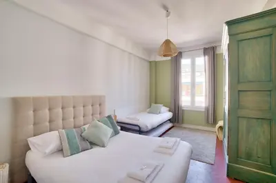 a living room with a white couch and a window at Stunning 2BR by the Port 20min Walk to the Beach in Nice