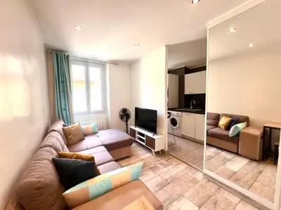 a living room with a couch and a television at Residence Lascaris in Nice