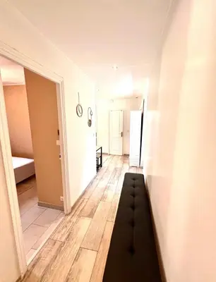 a hallway with a black couch in a room at Residence Lascaris in Nice