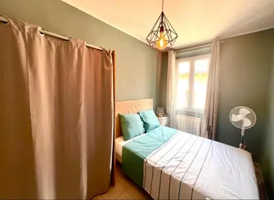 a small bedroom with a bed and a window at Residence Lascaris in Nice