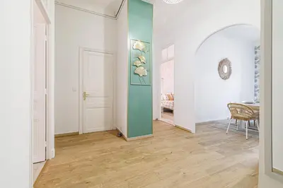 a hallway with white walls and a green wall at 36 STALNGRAD - Appartement spacieux - Le Port - 6 pers in Nice