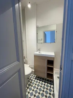 a bathroom with a sink and a toilet and a mirror at Appartement Nice Centre Palais OPHELIA in Nice