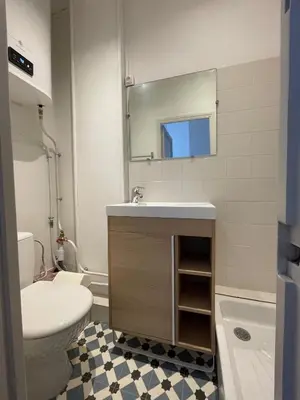 a bathroom with a sink and a toilet and a mirror at Appartement Nice Centre Palais OPHELIA in Nice