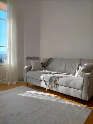 a living room with a couch and a window at L'Essentiel à Nice in Nice
