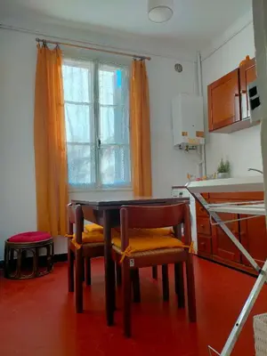 a kitchen with a table and two chairs and a window at L'Essentiel à Nice in Nice
