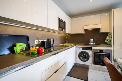 a kitchen with white cabinets and a dishwasher at Jardin Wilson AP4455 by RIVIERA HOLIDAY HOMES in Nice