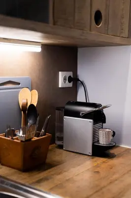 a closet with wooden cabinets and boxes in it at Studio à 2min à pieds de la mer et du Casino in Beaulieu-sur-Mer