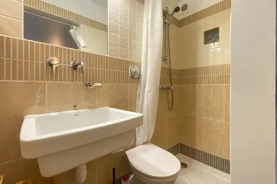 a large white bed in a room with at Studio à 2min à pieds de la mer et du Casino in Beaulieu-sur-Mer