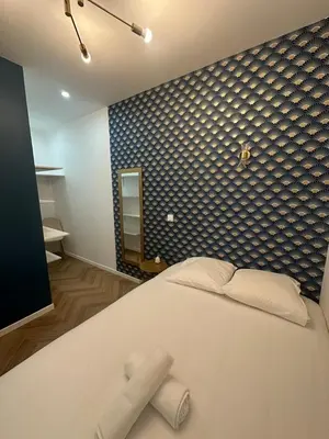 a bedroom with a large white bed and a blue wall at Appartement 2 chb 1 SDB Nice - 32 in Nice