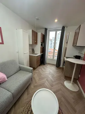 a living room with a couch and a table at MOON - 33 in Nice