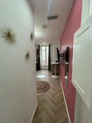 a hallway with a room with pink walls at MOON - 33 in Nice