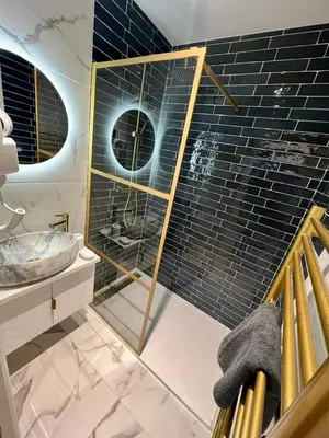 a bathroom with a glass shower and a sink at MOON - 34 in Nice