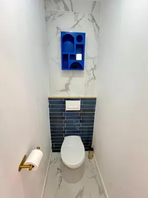 a bathroom with a white toilet and blue tiles at MOON - 34 in Nice