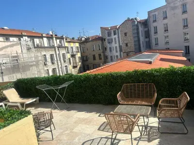 a group of chairs and a table on a patio at MOON - 35 in Nice