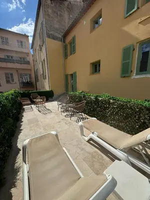 a group of chairs and tables in front of a building at MOON - 35 in Nice