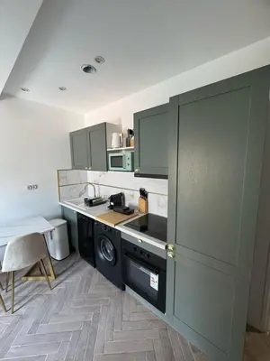 a kitchen with green cabinets and a counter top at MOON - 35 in Nice