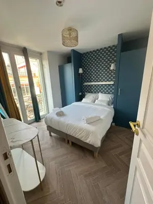 a bedroom with a large bed and a table at MOON - 44 in Nice