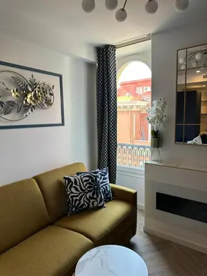 a living room with a couch and a fireplace at MOON - 44 in Nice
