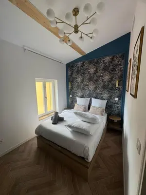 a bedroom with a large bed with a ceiling at MOON - 45 in Nice