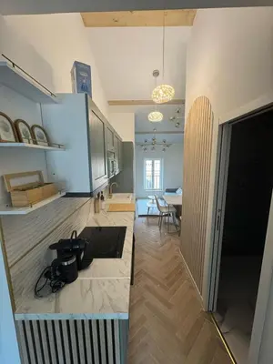 a kitchen with a counter and a dining room at MOON - 47 in Nice