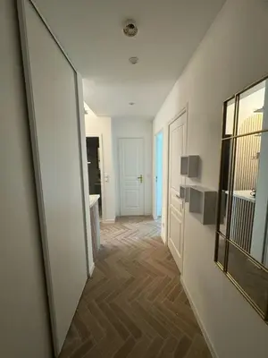a hallway with a large mirror and a bathroom at MOON - 47 in Nice