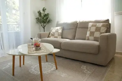 a living room with a couch and a table at Appartement à 5 min de la plage Soleil & Confort in Nice