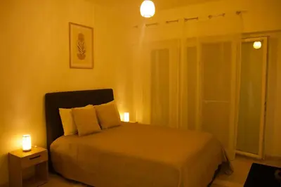 a bedroom with a bed with two lights on it at Appartement à 5 min de la plage Soleil & Confort in Nice