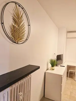 a room with a desk and a clock on the wall at appartement 1 pégurier in Nice