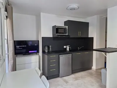 a small kitchen with a sink and a microwave at appartement 2 pégurier in Nice