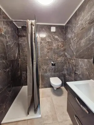 a bathroom with a shower and a toilet and a sink at appartement 2 pégurier in Nice
