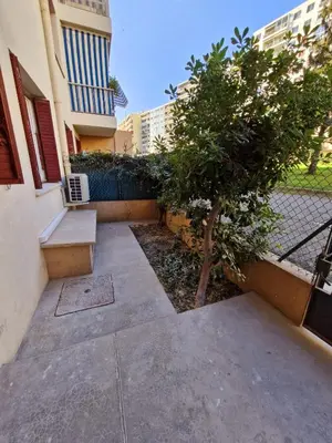 a sidewalk with a tree and a building at appartement 2 pégurier in Nice