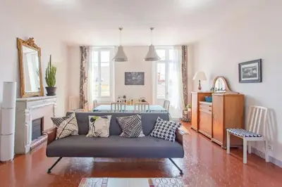 a living room with a couch and a fireplace at PANTHEON- App centre, 2 ch, 2 sdb , classé 4 étoiles in Nice