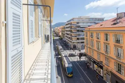 a tram on a street in a city with buildings at PANTHEON- App centre, 2 ch, 2 sdb , classé 4 étoiles in Nice
