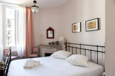 a bedroom with a bed with two white pillows at PANTHEON- App centre, 2 ch, 2 sdb , classé 4 étoiles in Nice