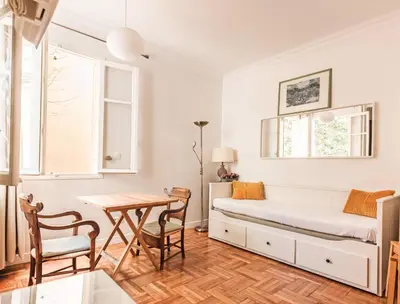 a bedroom with a bed and a table at FLEUR- Cosy Studio, 200 Promenade des Anglais et Negresco, wifi, climatisation- calme in Nice