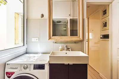 a kitchen with a sink and a washing machine at FLEUR- Cosy Studio, 200 Promenade des Anglais et Negresco, wifi, climatisation- calme in Nice