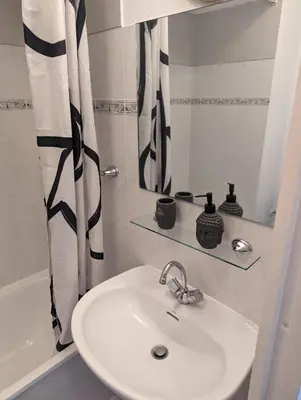 a bathroom with a sink and a shower curtain at Nice center - 2 person apartment in Nice