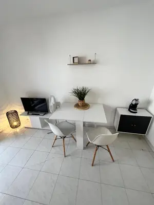 a living room with a white table and chairs at Nice center - 2 person apartment in Nice