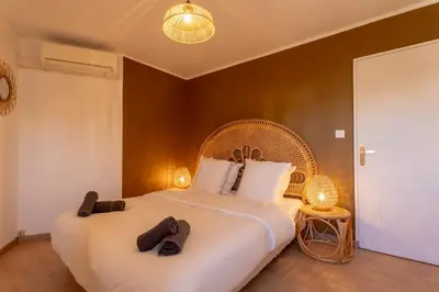 a bedroom with a large bed with two slippers on it at Le Sunrise in Nice