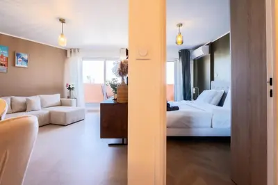a room with a bed and a living room at Le Sunrise in Nice