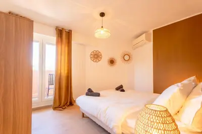 a bedroom with a white bed and a window at Le Sunrise in Nice