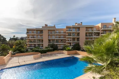 a large apartment building with a large swimming pool at Happyfew appartement les palmiers in Nice